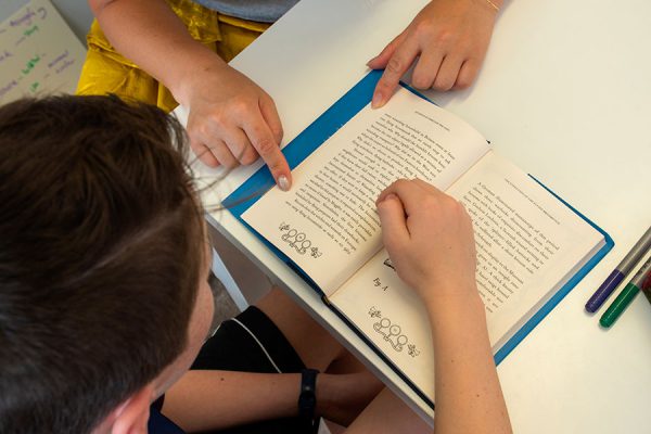 close-up-of-book-with-clinician-and-client