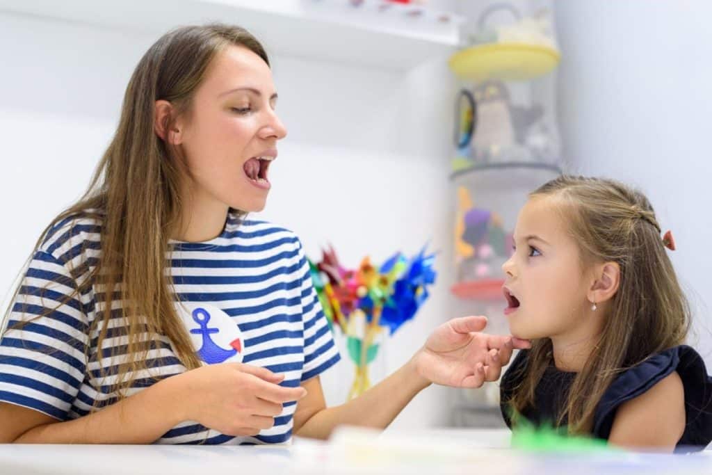 Speech Therapist assisting child with Childhood Apraxia of Speech