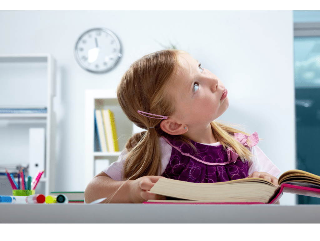 Young girl looking thoughtful while holding a book, representing reluctant readers who struggle to stay engaged