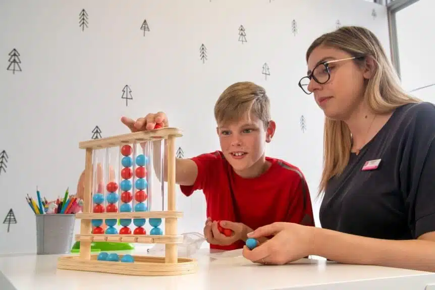 - A child playing a game during a speech therapy session