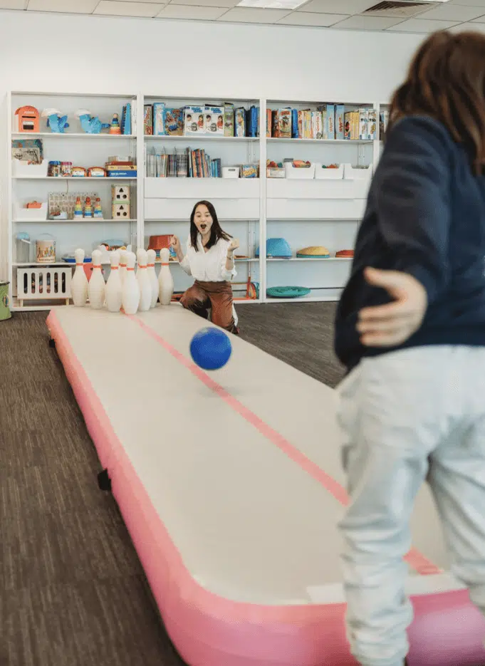 - Speech pathologist using action based play to engage client in speech therapy session
