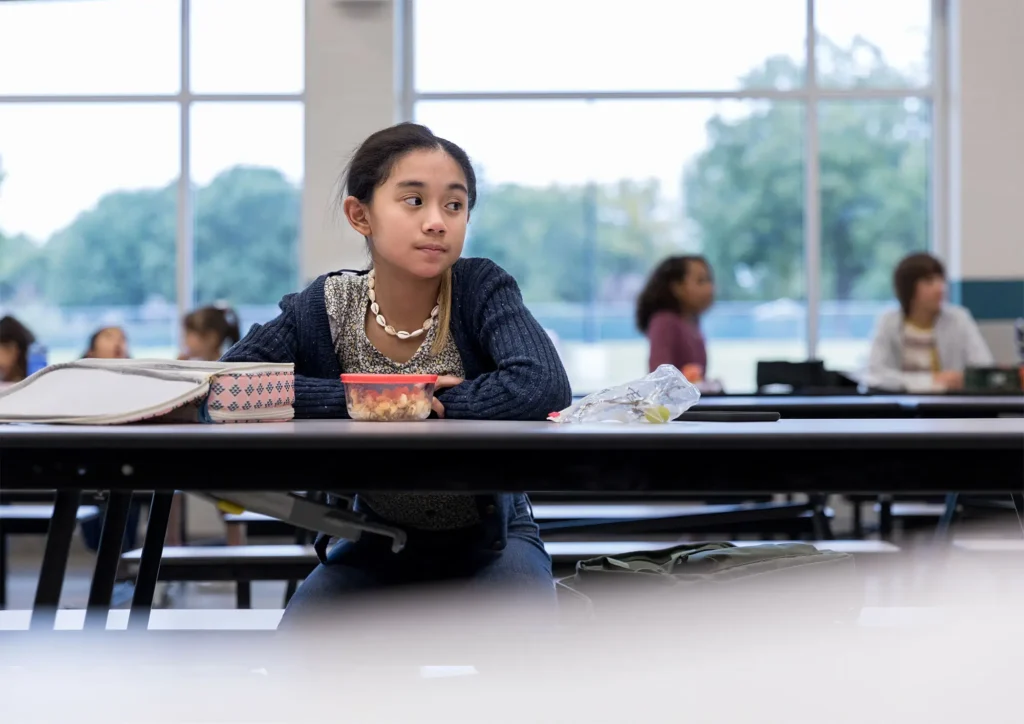 Girl sitting alone in a quiet room showing signs of selective mutism and neurodivergent shutdown