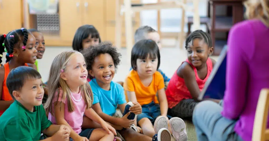 Lady-Speech-pathologist-leading-a-school-readiness-therapy-group-with-nine-children-scaled