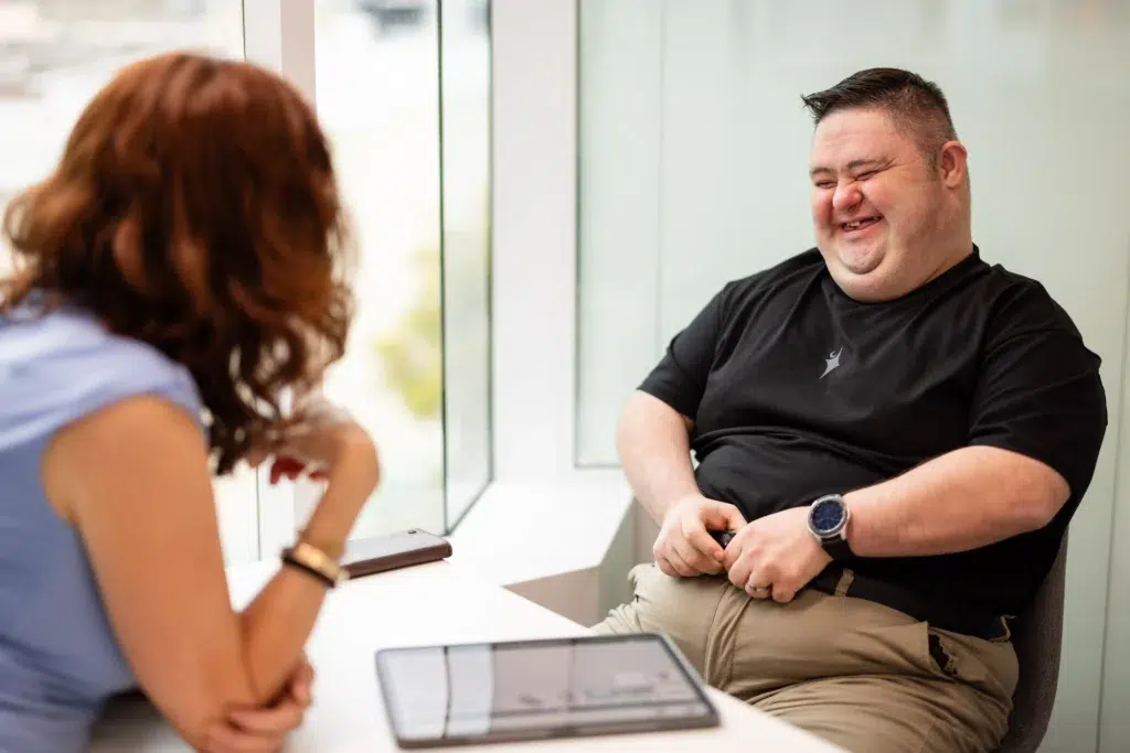 Speech therapy session with a speech pathologist using an iPad to support an NDIS participant during speech pathology activities