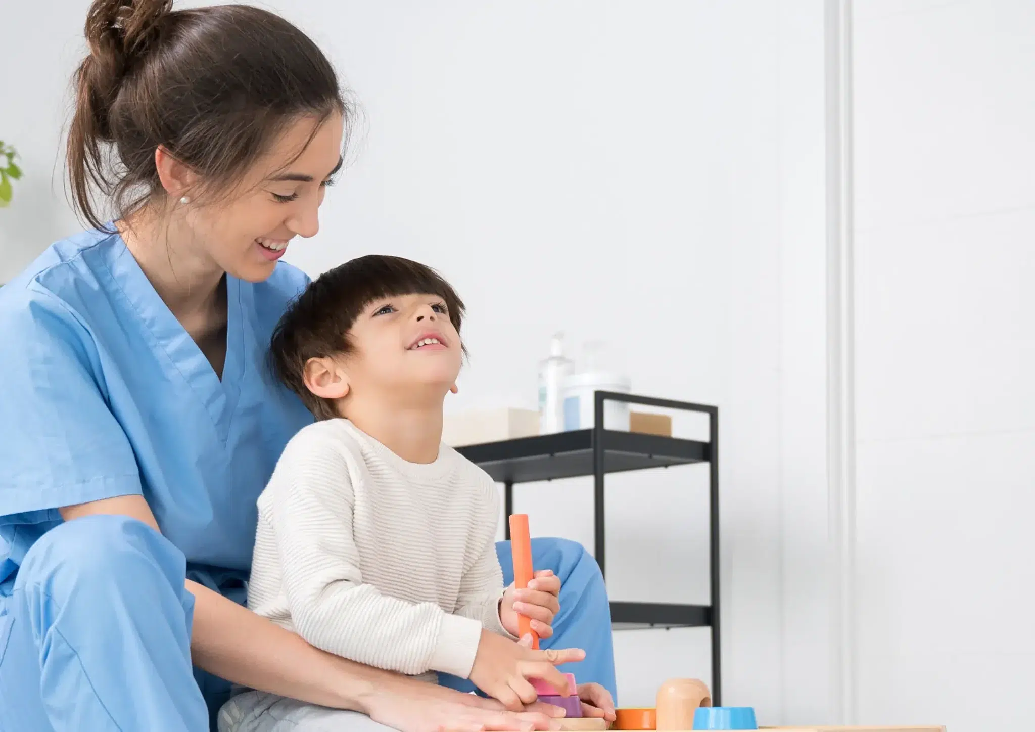 Speech pathology for cerebral palsy through play-based interaction between a speech pathologist and a boy