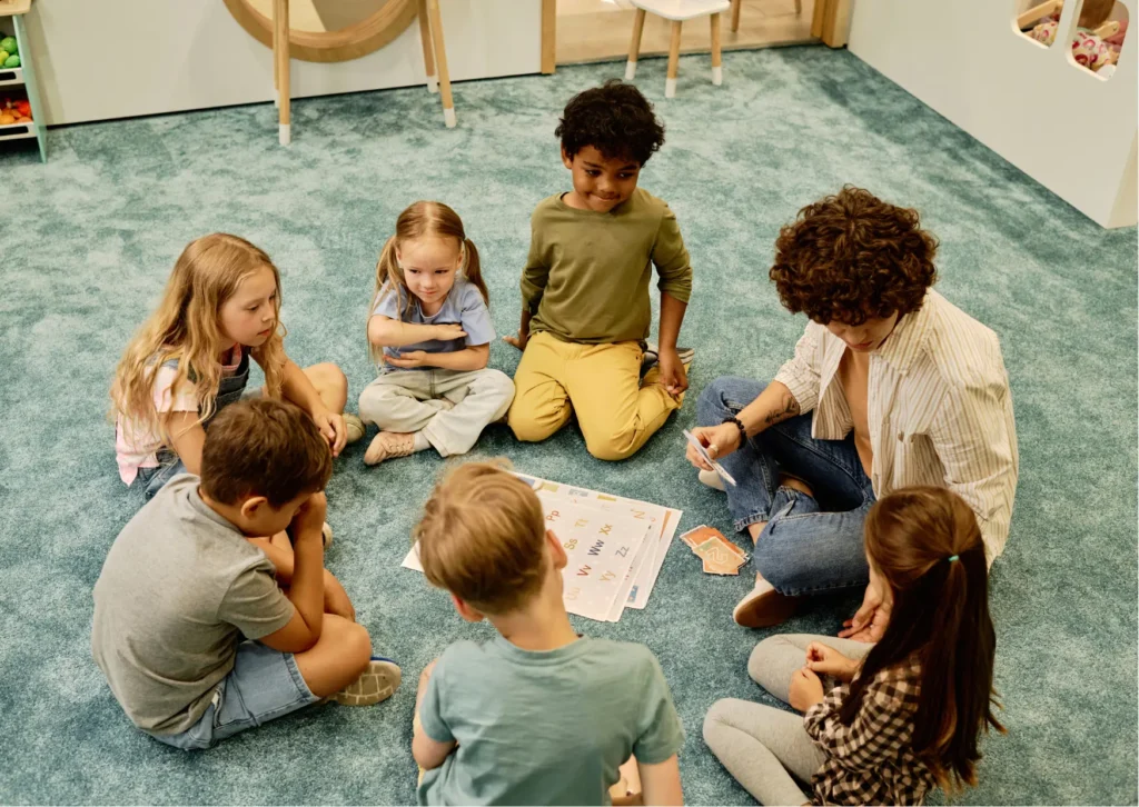 Group therapy session for kids with a speech pathologist providing speech pathology support through interactive learning activities