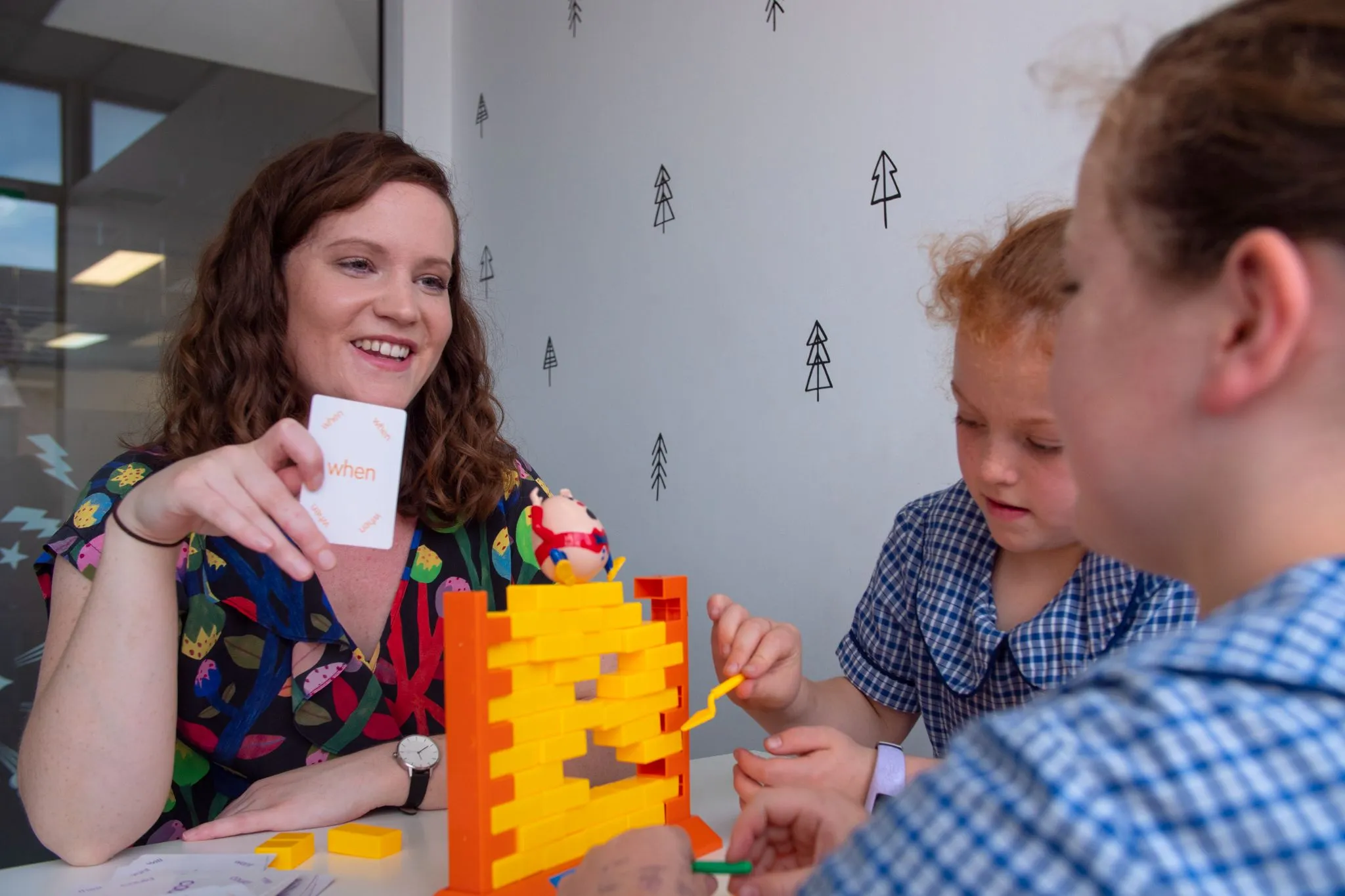 Two kids participating in a speech therapy activity involving matching cards, a common method for correcting sound errors associated with an articulation disorder.
