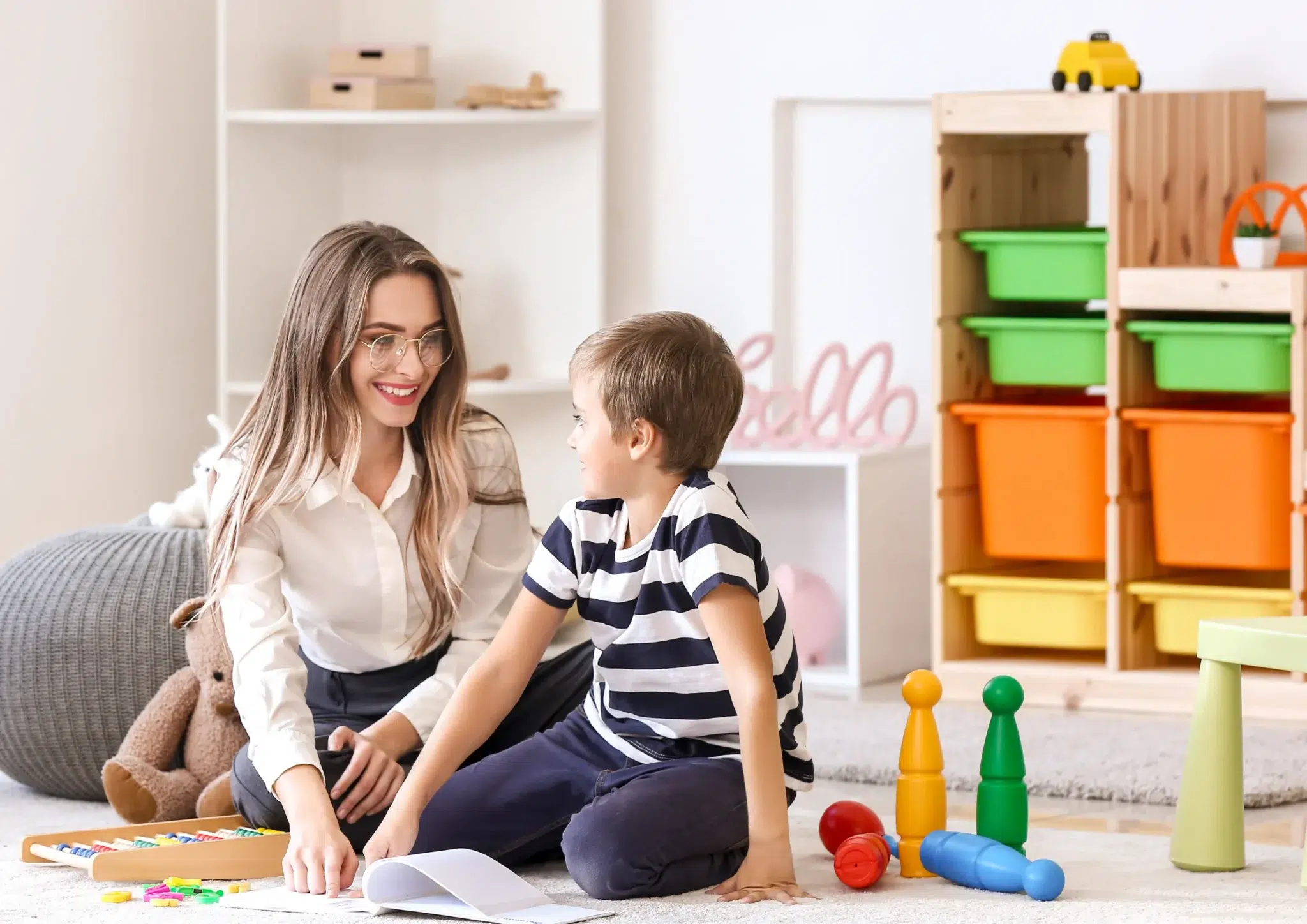 Speech-pathologist-reading-a-book-with-a-child-with-hyperlexia-during-a-therapy-session