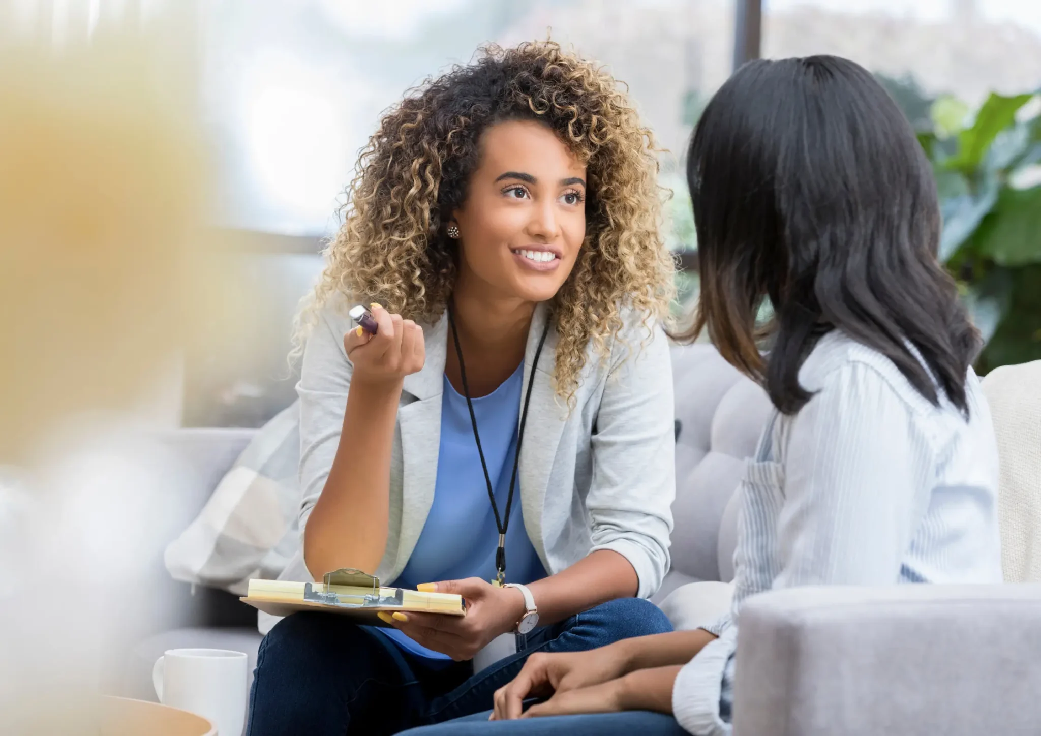Adult woman practising turn-taking skills during a pragmatics speech therapy session with a speech pathologist in a clinic