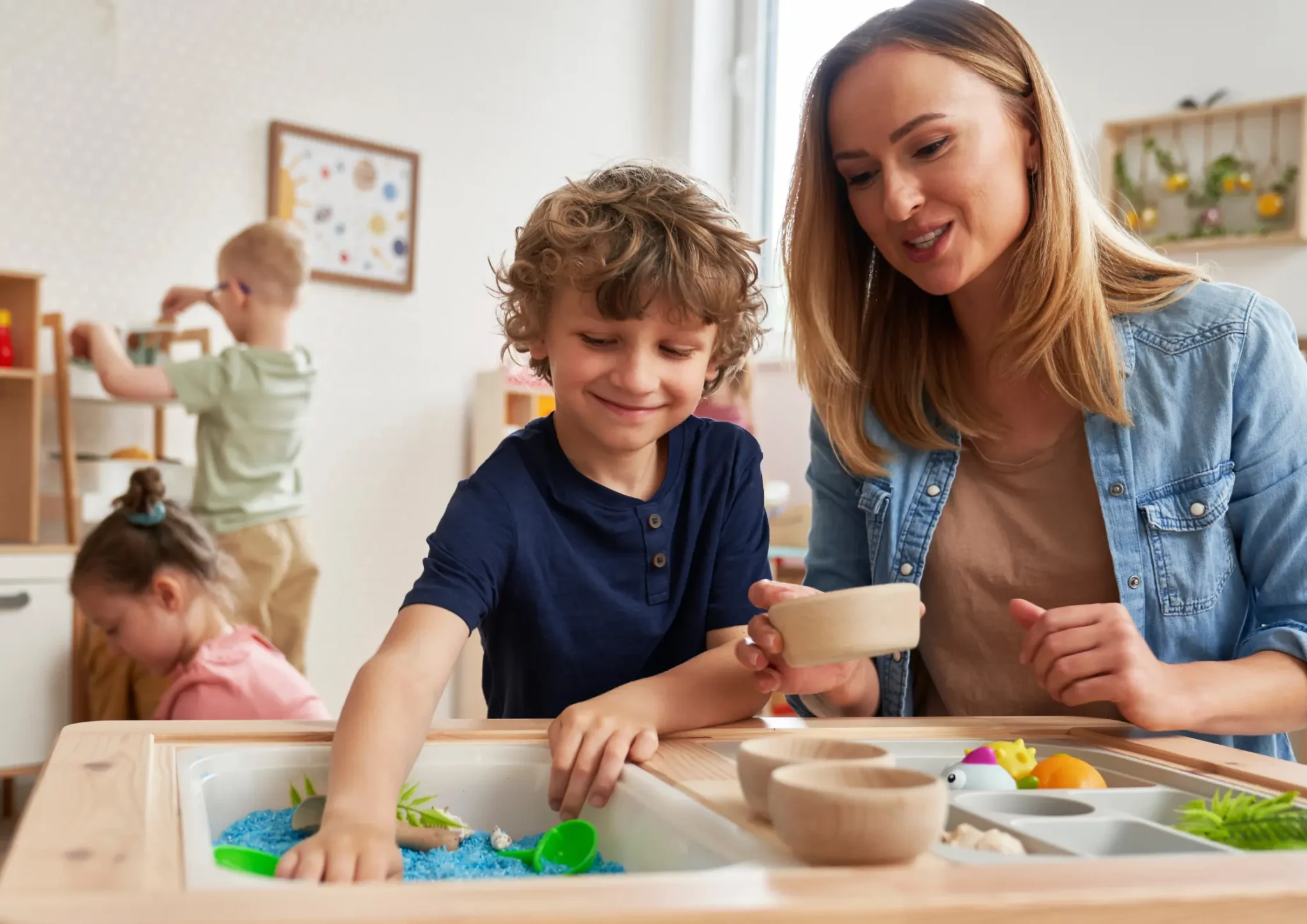 Speech therapy session with a speech pathologist and an NDIS participant using sensory toys to support Sensory Motor Processing Disorder