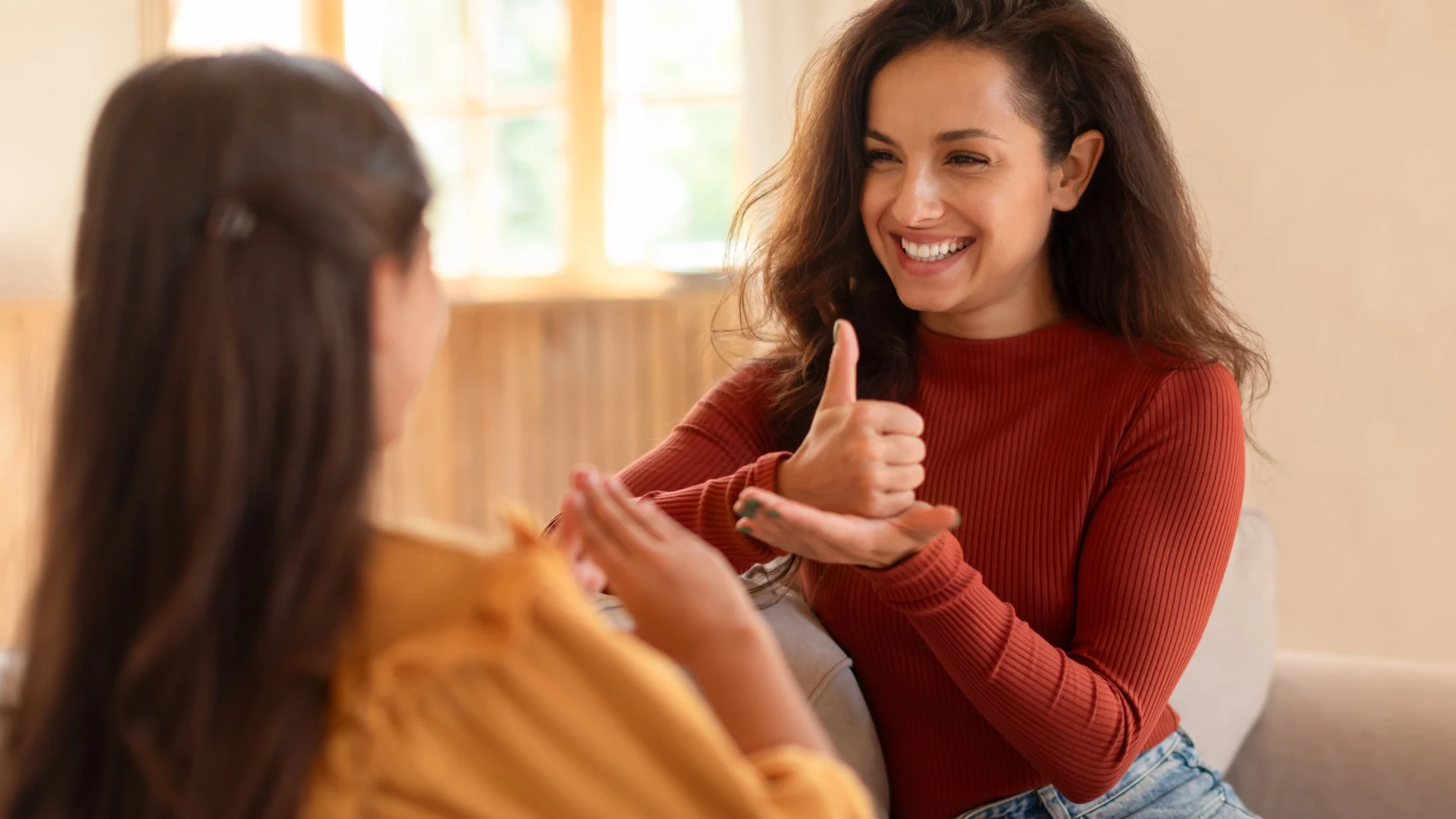 Speech pathologist holding up a picture card during a play-based session with a child, part of using sign language and speech therapy together